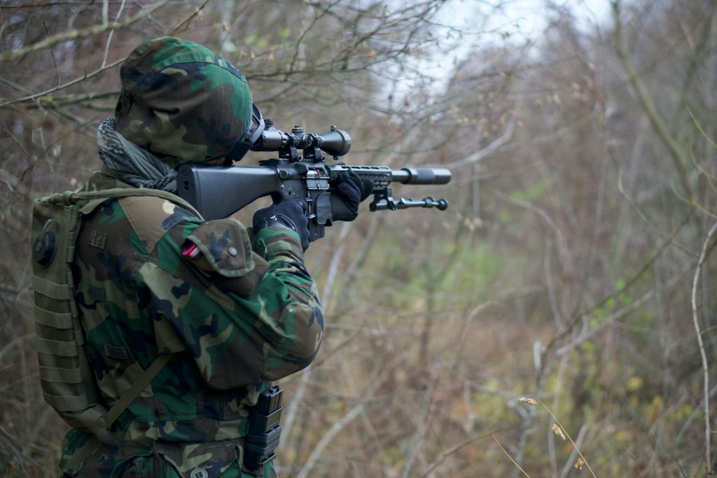 person holding assault rifle